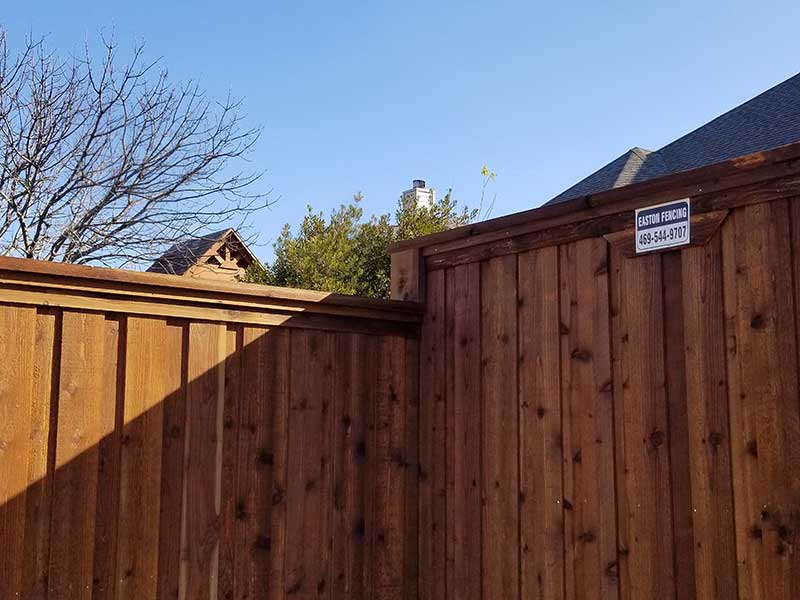 How to fix a leaning fence: a straight cedar fence with posts set in concrete